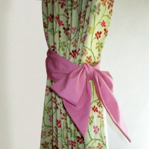 Green floral curtains with bright pink tie back