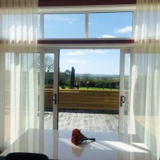 White roller blinds in a large window/patio door