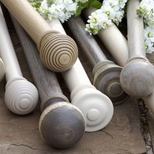 Natural coloured wooden and metal curtain poles
