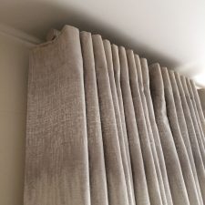 Satin beige curtains on metal pole