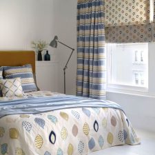 Blue and yellow patterned blinds, curtains, bed valance, bedding and cushions