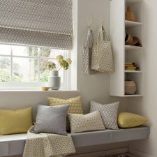 Room with yellow and grey patterned soft furnishings